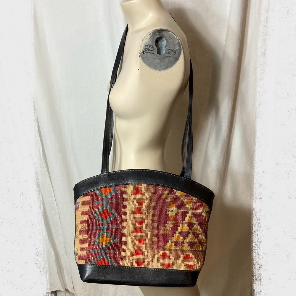 Kilim rug woven textile tapestry black leather handbag vintage